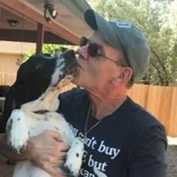 Doug Rae, Executive Director of The Humane Society of Fremont County shown kissing one of his favorite dogs